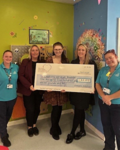 Palmers team delivering cheque to charity